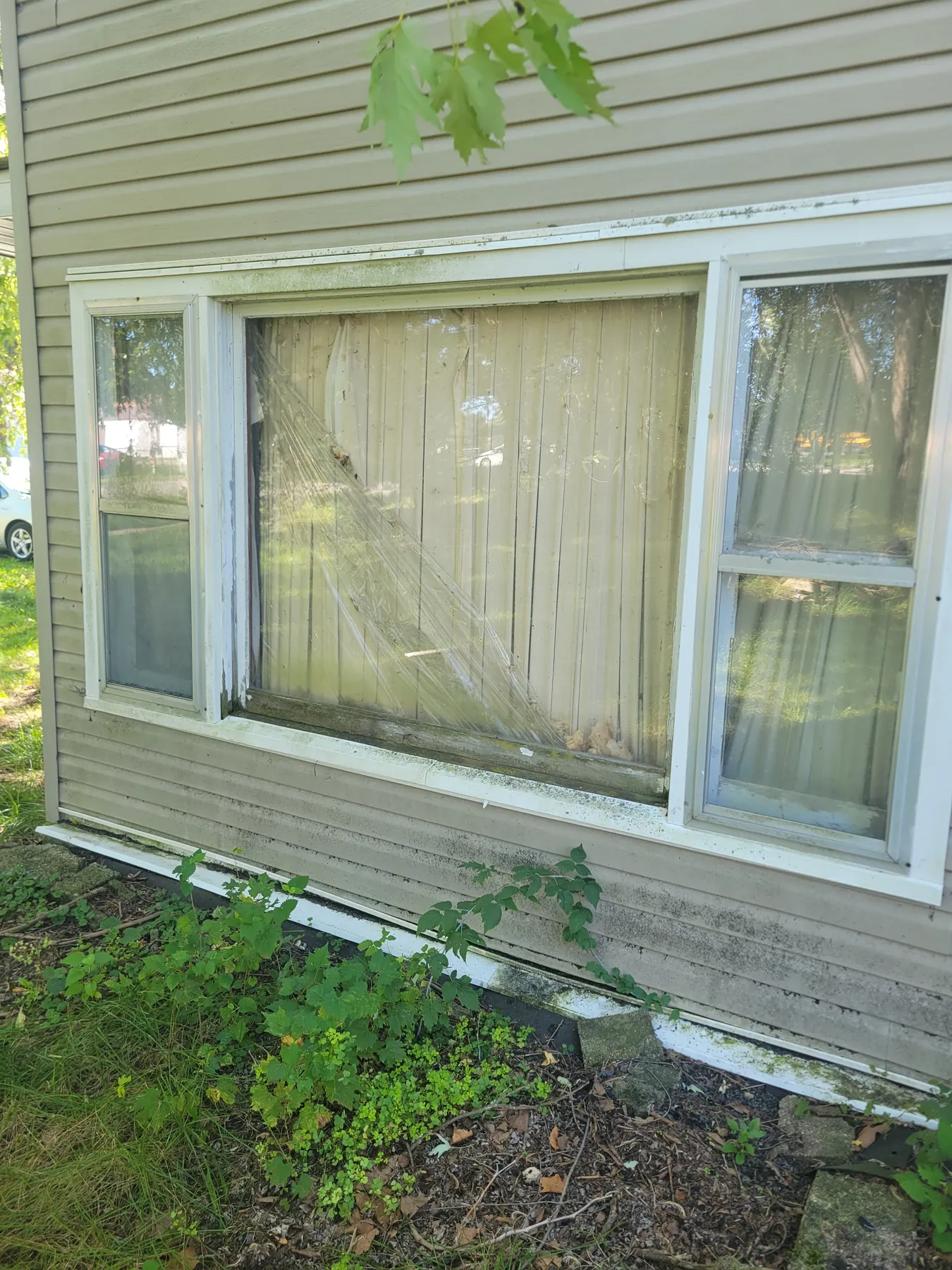 Deteriorated exterior window and siding conditions at 2077 Elliott Street