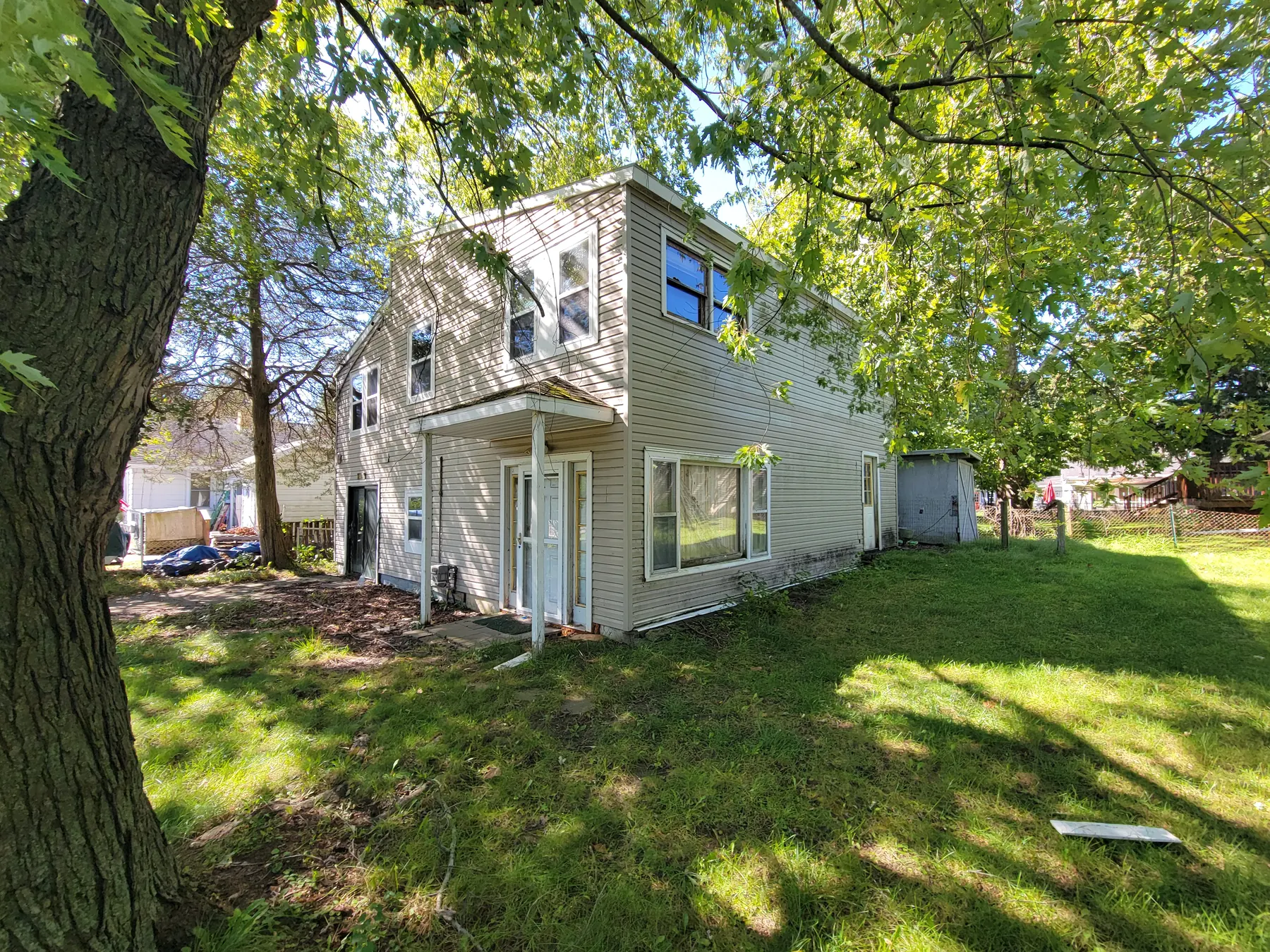 Rear and side exterior of 2077 Elliott Street in Holt during the We Buy Lansing inspection