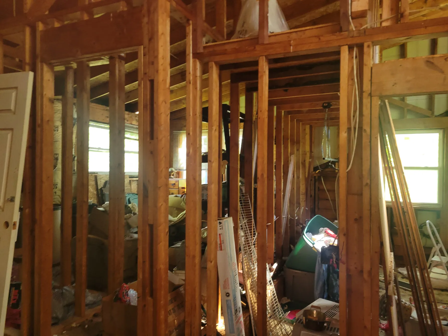 Gutted interior with exposed wall framing at 2077 Elliott Street