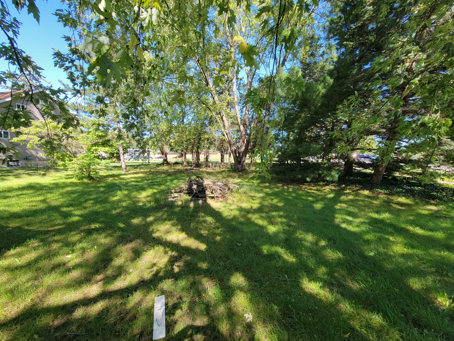 Wide view of the corner parcel and yard at 2077 Elliott Street in Holt